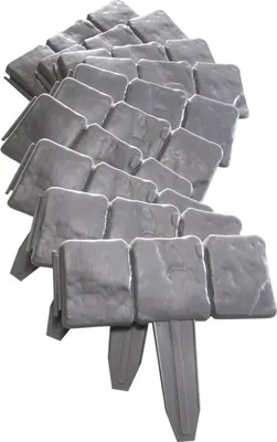 A pile of grey garden edging stones with stakes.