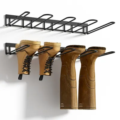 Two black metal boot racks mounted on a white wall, with pairs of boots hanging from them.