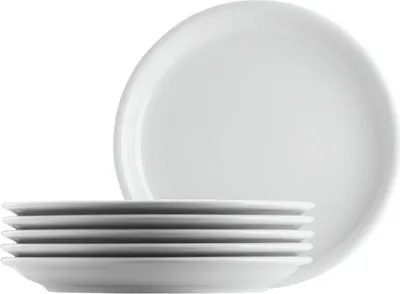 A stack of white plates with one large plate in the background.
