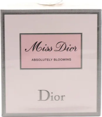 Verpackung von Miss Dior Absolutely Blooming Eau de Parfum in zartem Rosa mit grauem Rahmen, eleganter Schrift und Dior-Logo auf hellem Hintergrund.