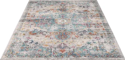 A flat lay of a rectangular rug with a distressed vintage pattern.