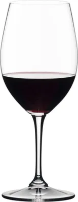 A clear studio shot of a red wine glass filled with red wine.