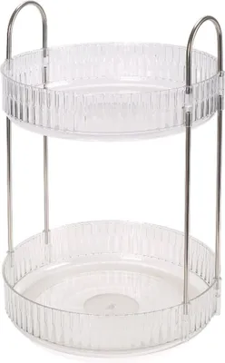 A two-tiered rotating organizer with clear plastic trays and silver metal supports.