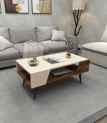A modern living room with a couch, coffee table, and floor lamp.