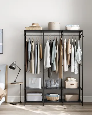 A bedroom scene with a clothing rack.