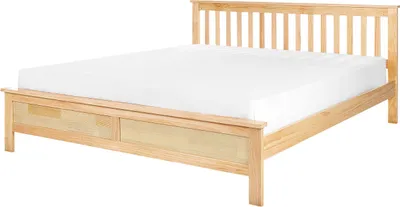 A wooden bed with a white mattress on a white background.
