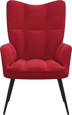 A red velvet armchair with black legs, shown from the front.