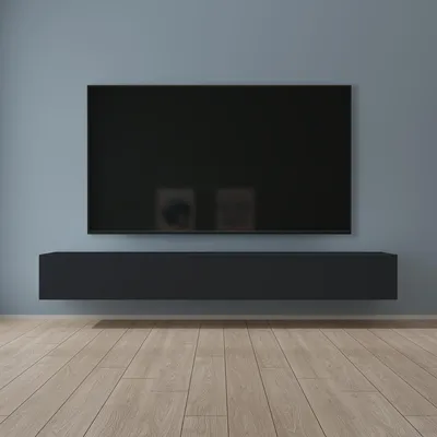 A modern living room with a wall-mounted television and a floating media console.