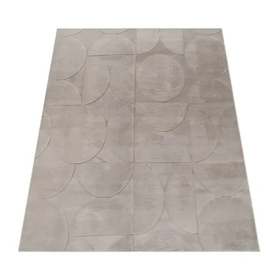 A gray rug with a geometric pattern of circles and semi-circles, laid flat on a white background.