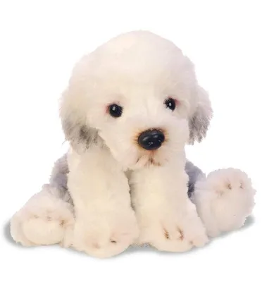 A stuffed toy dog sitting on a white background.