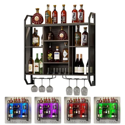 A multi-tiered wine rack filled with various bottles of wine and liquor, with wine glasses hanging from the bottom rack.