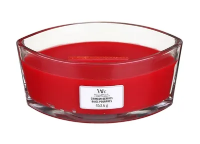 A red WoodWick candle in a clear glass container.