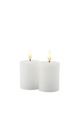 Two white LED candles with flickering flames are shown against a white background.