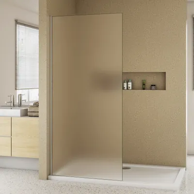 A modern bathroom with a frosted glass shower door, vanity, and sink.