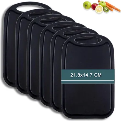 A set of black cutting boards is displayed, with a small graphic of fruits and vegetables in the upper right corner.