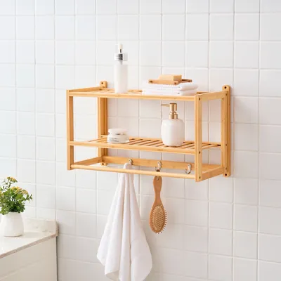 A wooden shelf with bathroom accessories mounted on a tiled wall.
