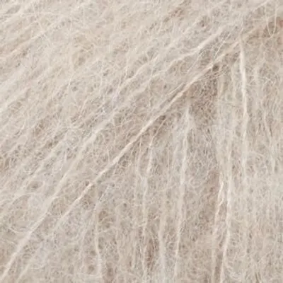 A close-up, textured view of light beige yarn.