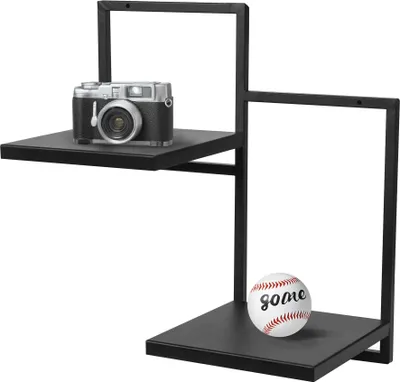 A black metal shelf unit with a camera on the top shelf and a baseball on the bottom shelf.