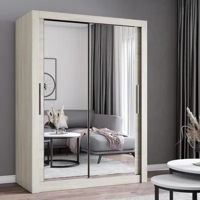 A modern sliding door wardrobe with mirrored doors, reflecting a living room setting with a sofa and coffee table.