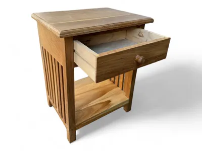 A wooden nightstand with an open drawer and a shelf below, presented against a white background.