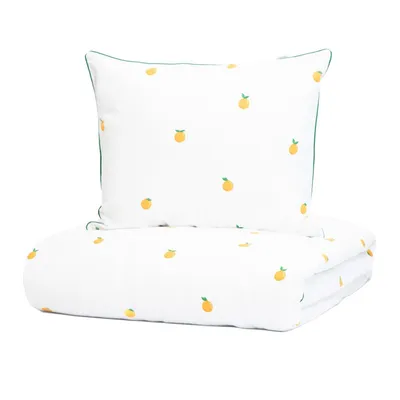 A folded duvet and a pillow with an orange pattern on a white background.