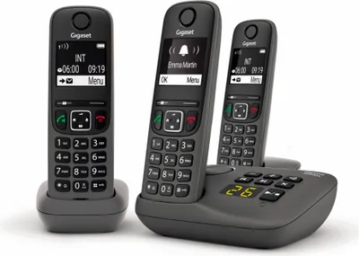 Three Gigaset cordless phones are displayed on a charging base against a white background.