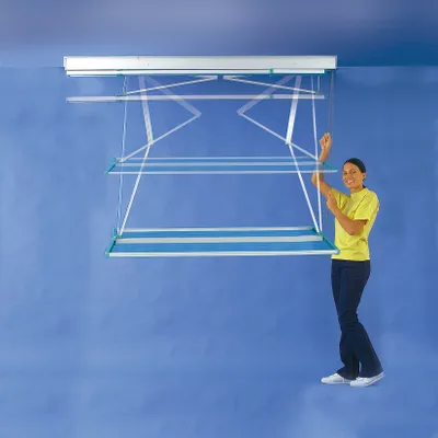 A woman is standing next to a ceiling-mounted clothes drying rack.