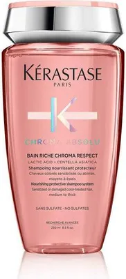 A pink bottle of Kerastase shampoo against a white background.