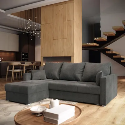 A modern living room with a large sectional sofa, a fireplace, a staircase, and a dining area.