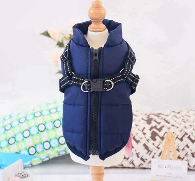 A blue dog vest with a harness is displayed on a mannequin.