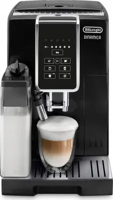 A black DeLonghi Dinamica coffee machine is shown from the front, with a glass of latte in the foreground.