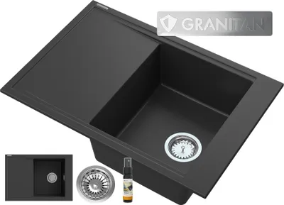 A black composite kitchen sink with a drainboard and accessories, presented in a studio setting.