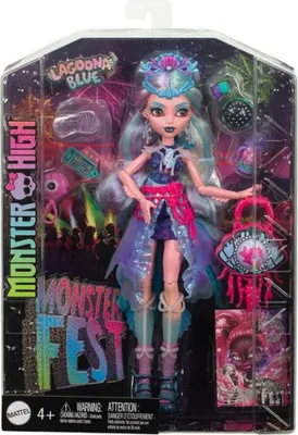 A Monster High doll named Lagoona Blue is displayed in her packaging, which is designed to look like a festival stage with colorful lights and silhouettes of a crowd.