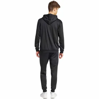 A man wearing a black Adidas tracksuit, viewed from the back.