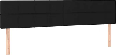 A black upholstered headboard with two wooden legs, presented against a white background.