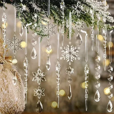 Christmas tree ornaments, including snowflakes and icicles, hanging from a branch.