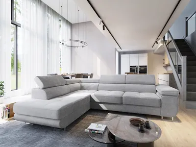 A modern living room with a large sectional sofa, dining area, and staircase.