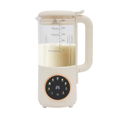 A cream-colored automatic soy drink maker filled with a light-colored liquid, shown on a white background.