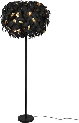 A black floor lamp with a shade made of black and gold leaves.