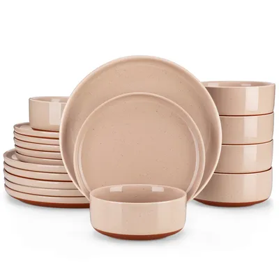 A set of pink ceramic dishes is neatly stacked and arranged on a white background.