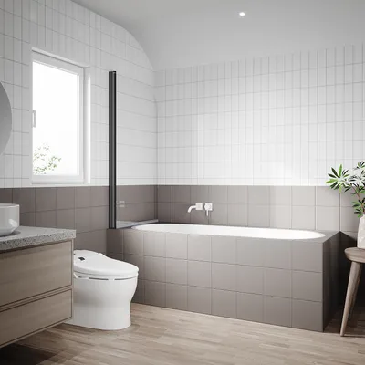 A modern bathroom with a bathtub, toilet, and vanity.