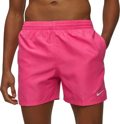 A person wearing pink Nike swim shorts.