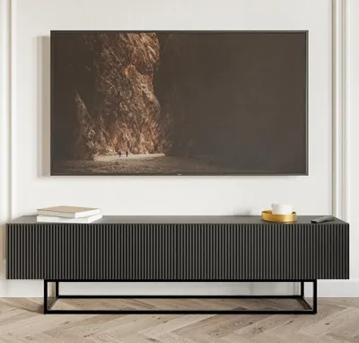 A black TV stand with a metal frame, displaying a large television screen with a landscape image.