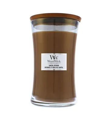 A WoodWick candle in a glass jar with a wooden lid.
