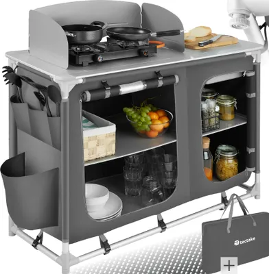 A camping kitchen setup with cooking utensils, food, and storage compartments.