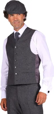 A man wearing a suit, vest, and cap.