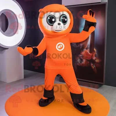 Produktbild von Orange REDBROKOLY Kamera Maskottchen kostümfigur bekleidet mit Yogahosen und Ringen