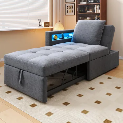 A gray sofa bed is shown in a room with a window and a bookshelf in the background. The sofa has a built-in shelf with blue LED lighting.