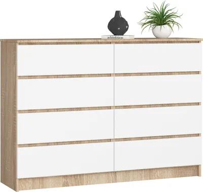 A dresser with white drawers and a wood-grain frame, decorated with a vase and a plant on top.