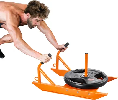 A man is using a weight sled for training.